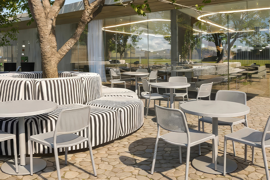 a patio with a couch and tables