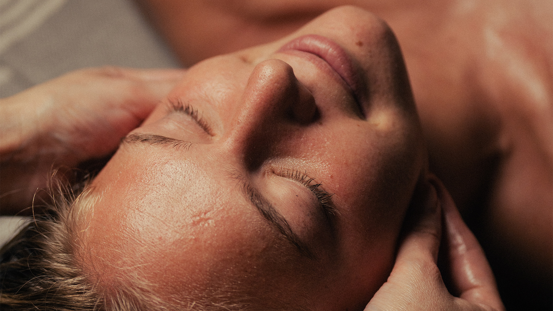 a woman lying down with her eyes closed