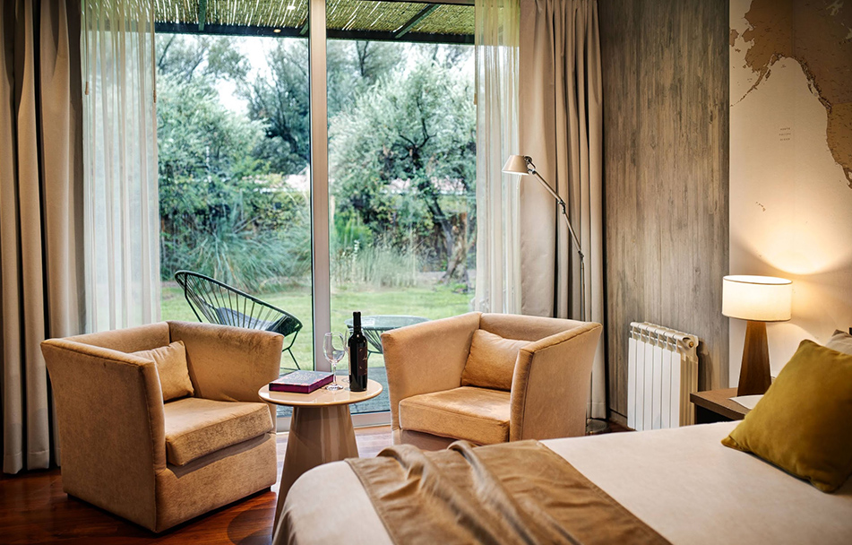 a room with a bed and chairs and a table