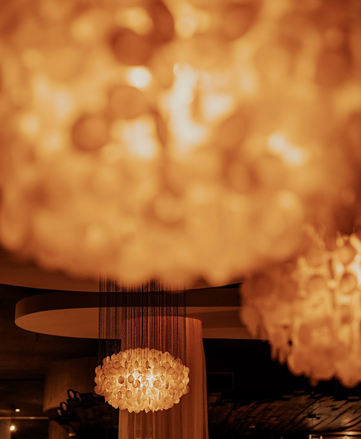 a chandelier with a light from the ceiling