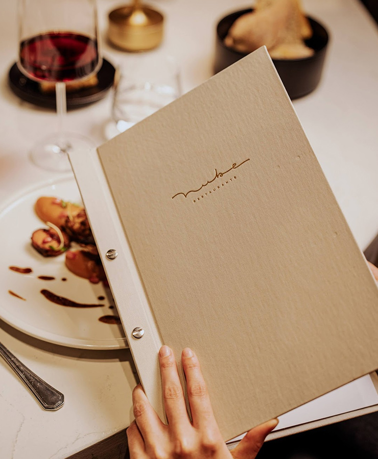 a person holding a menu