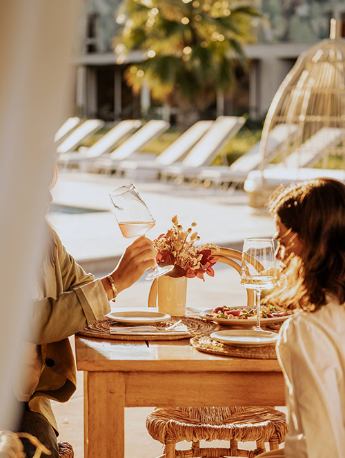 a man and woman drinking wine at a table