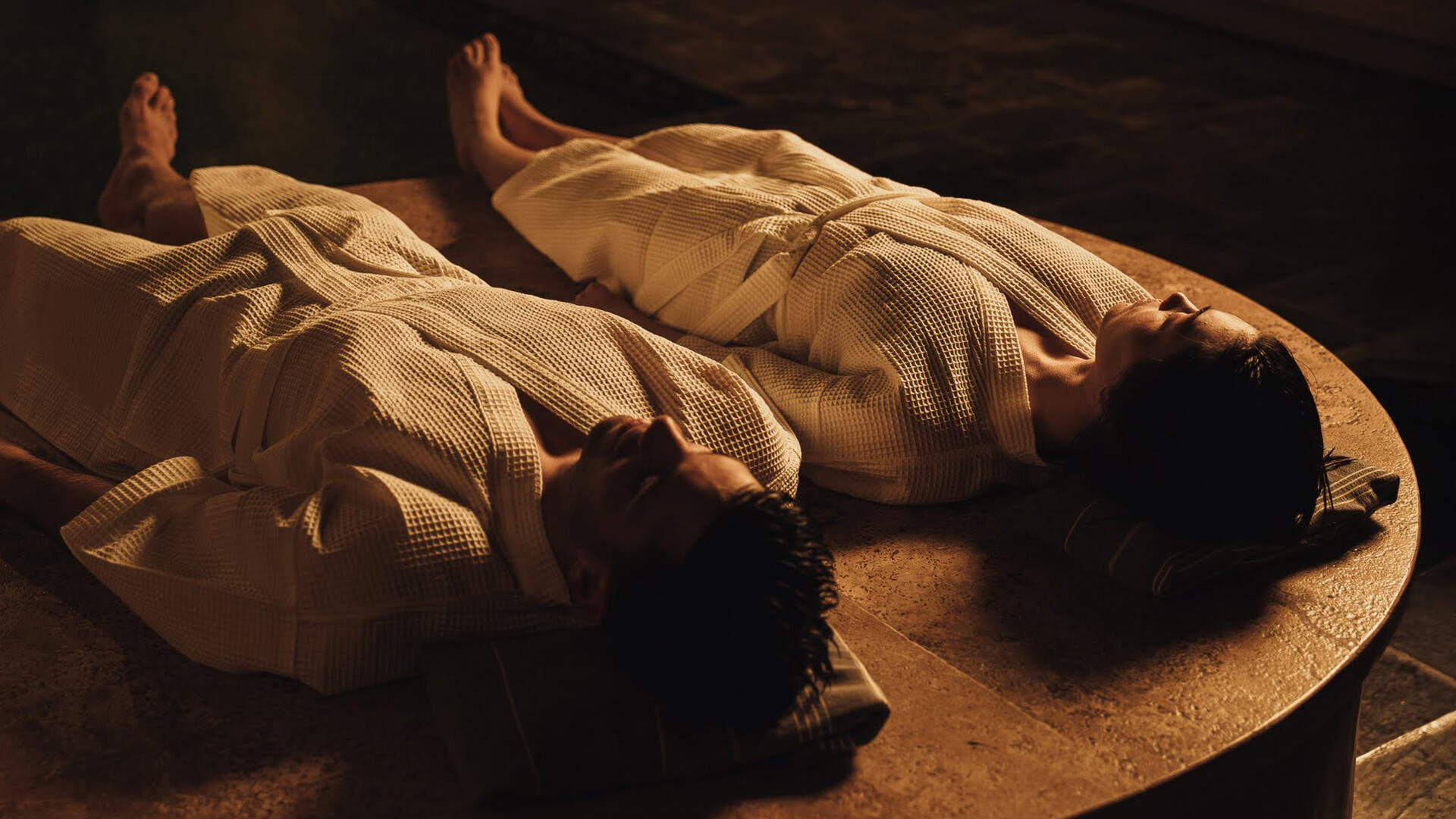 a couple of people lying on a table