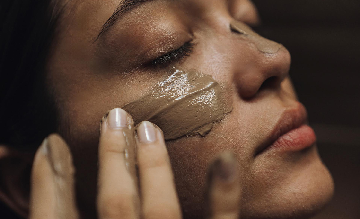 a woman with brown facial mask