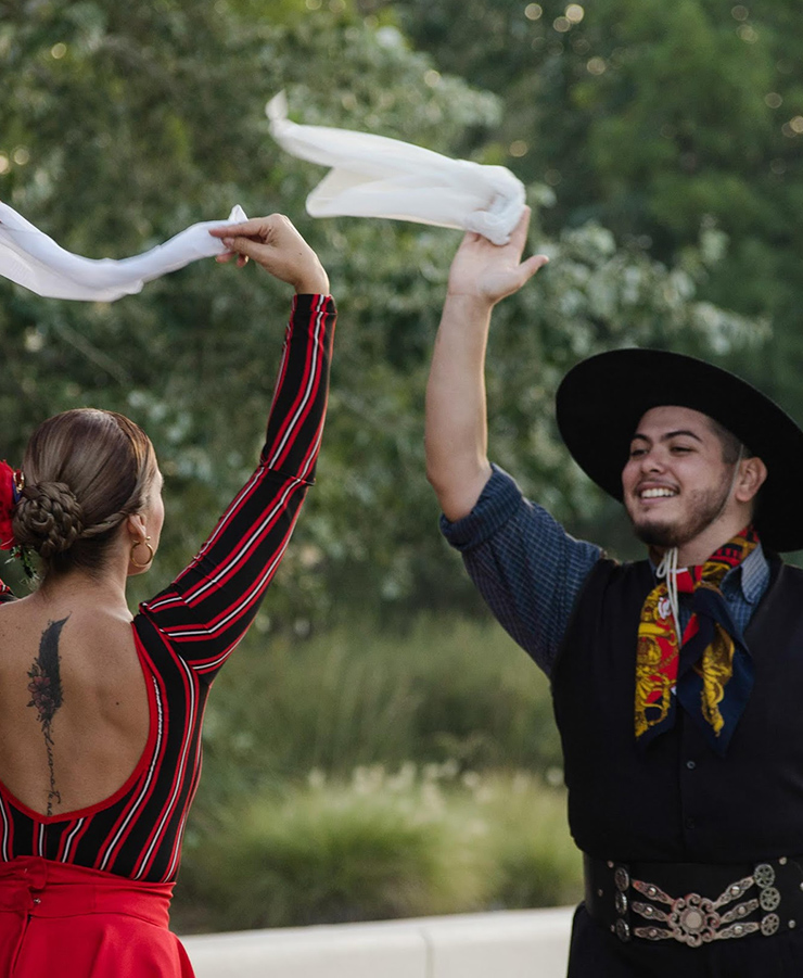a man and woman holding white scarves
