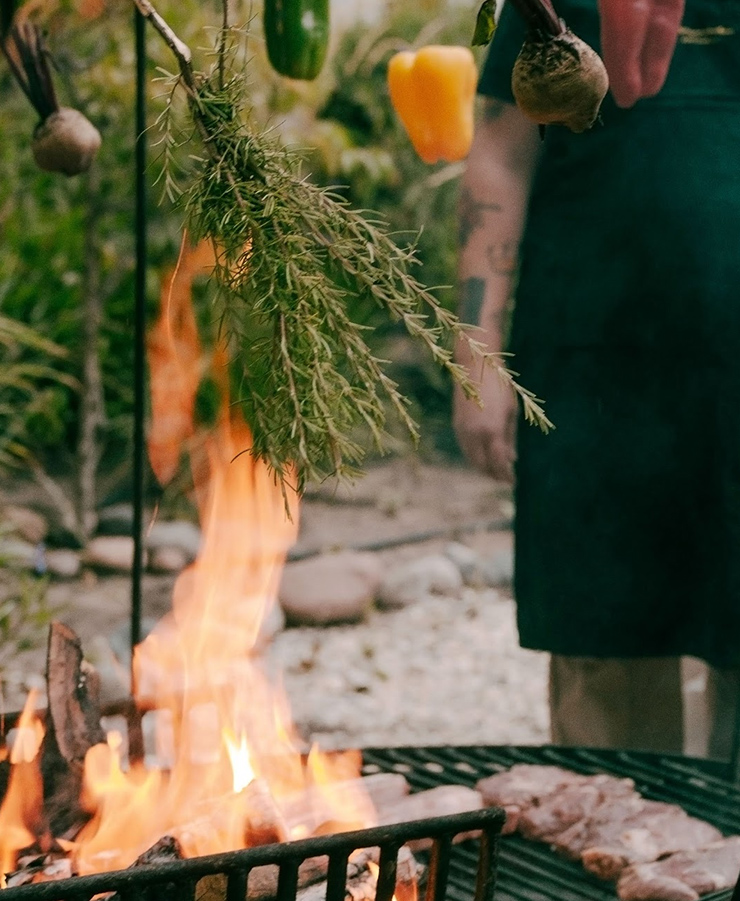 a person cooking food over a fire