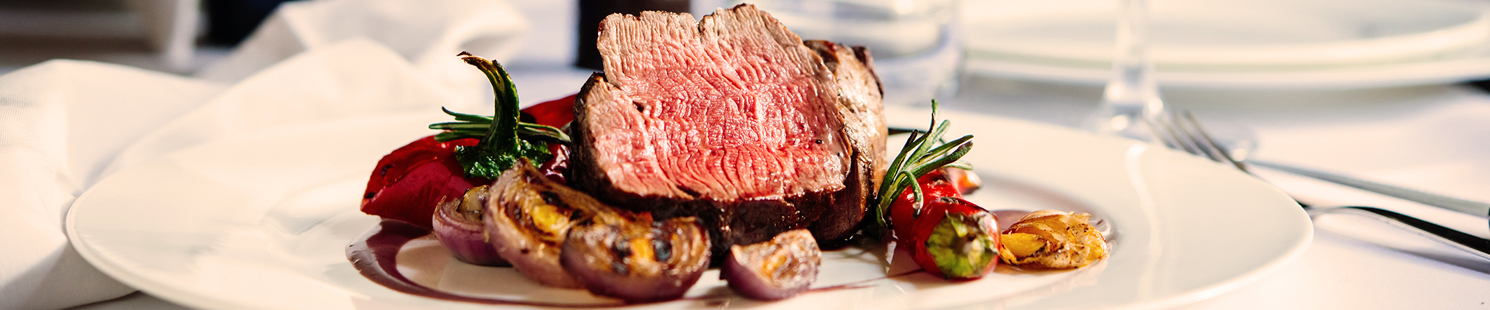 a piece of meat with vegetables on a plate