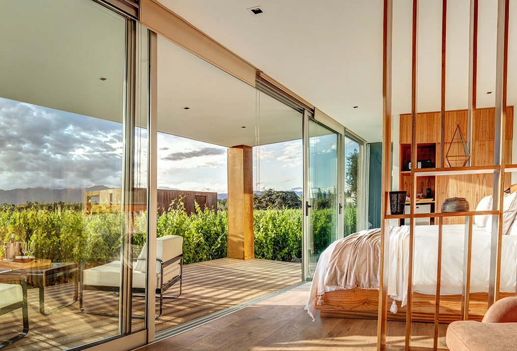a bedroom with glass doors and a deck