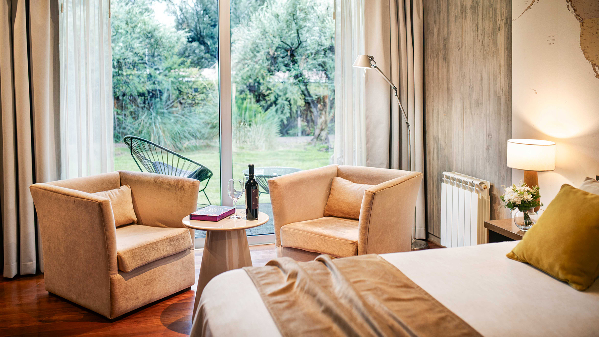 a room with a bed and chairs and a table