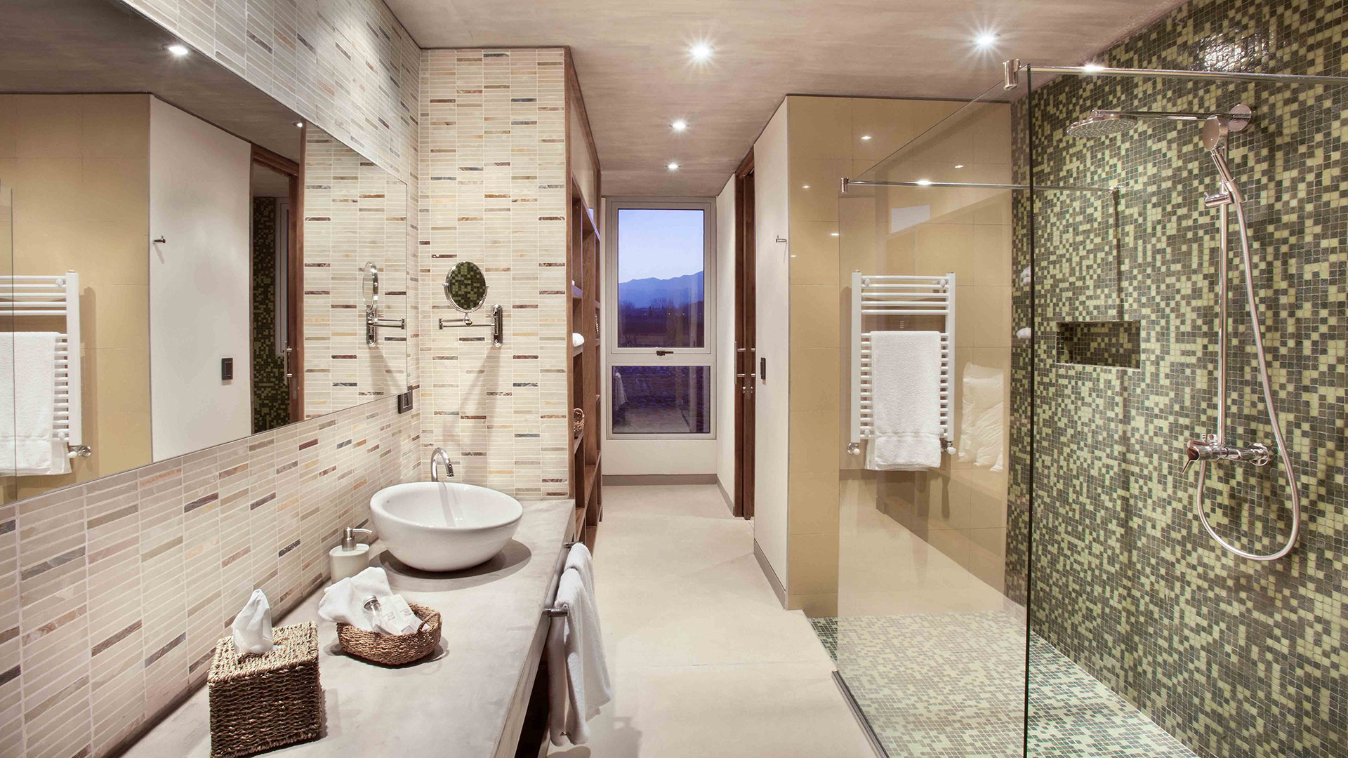 a bathroom with a glass shower and sink