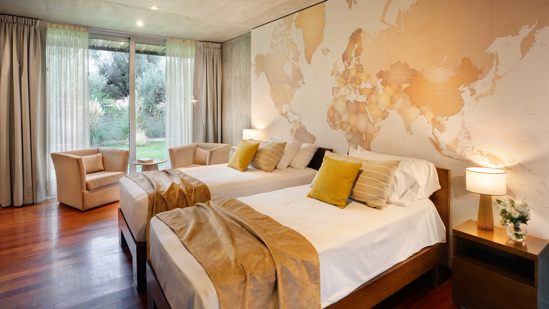 two beds in a room with a map of the world