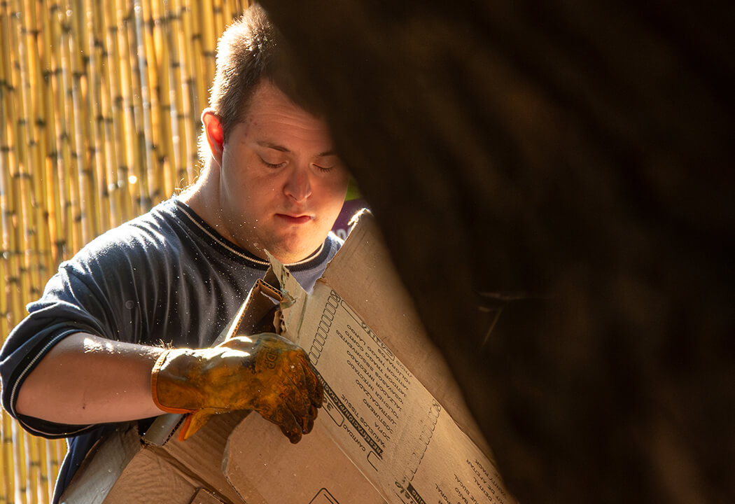 a man looking at a cardboard box