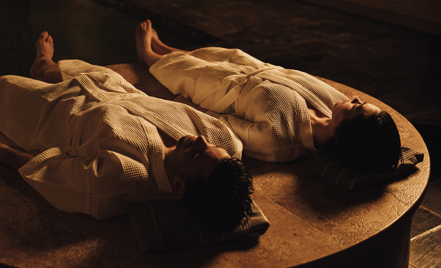 a man and woman lying on a table