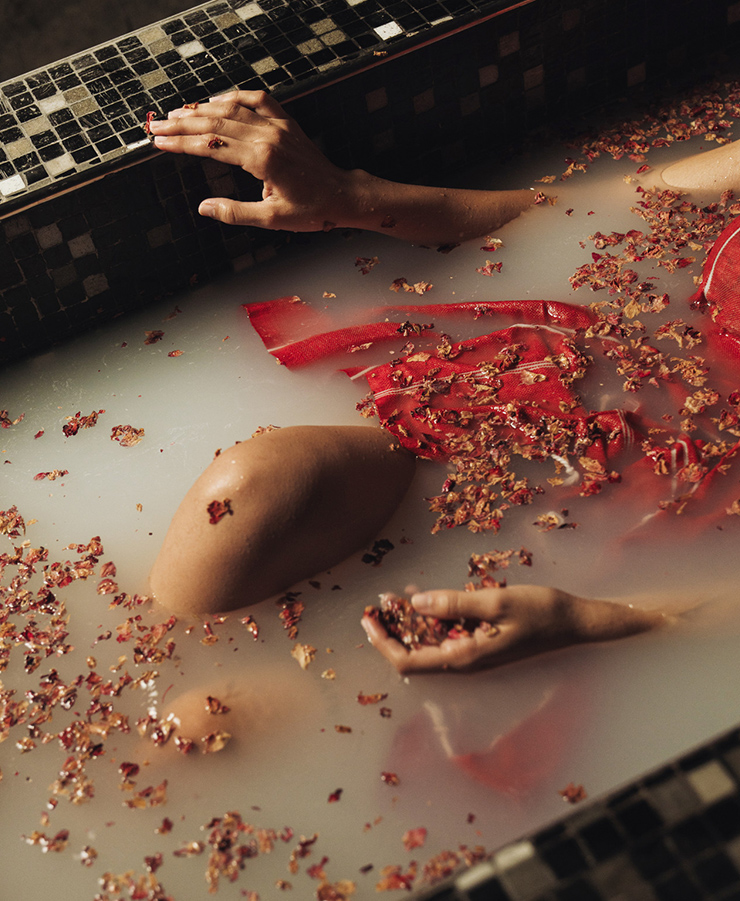a person in a bath with a red dress