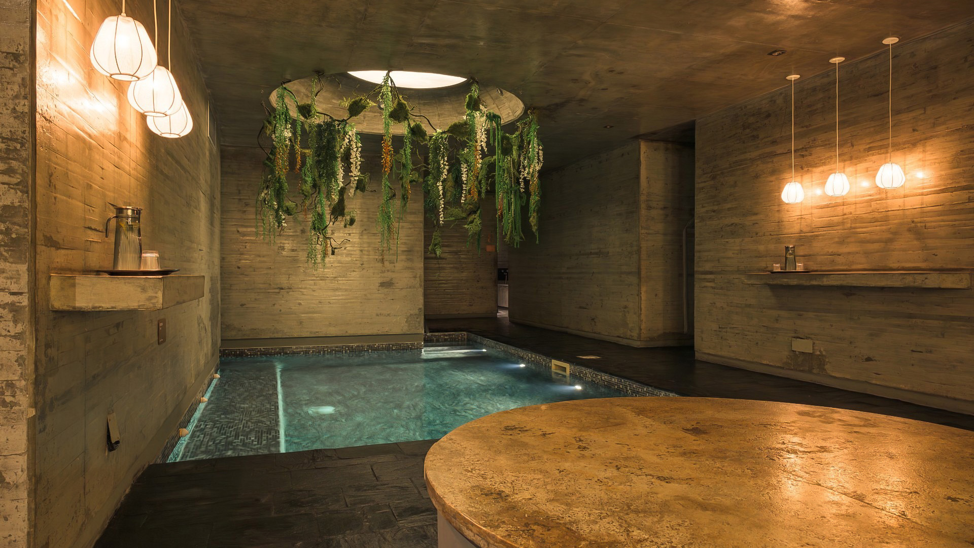 a indoor pool with plants from the ceiling