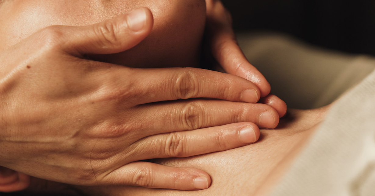 a person's hands on the chest of a person