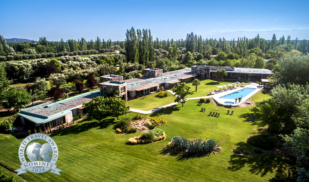 a large building with a pool in the middle of a grassy area