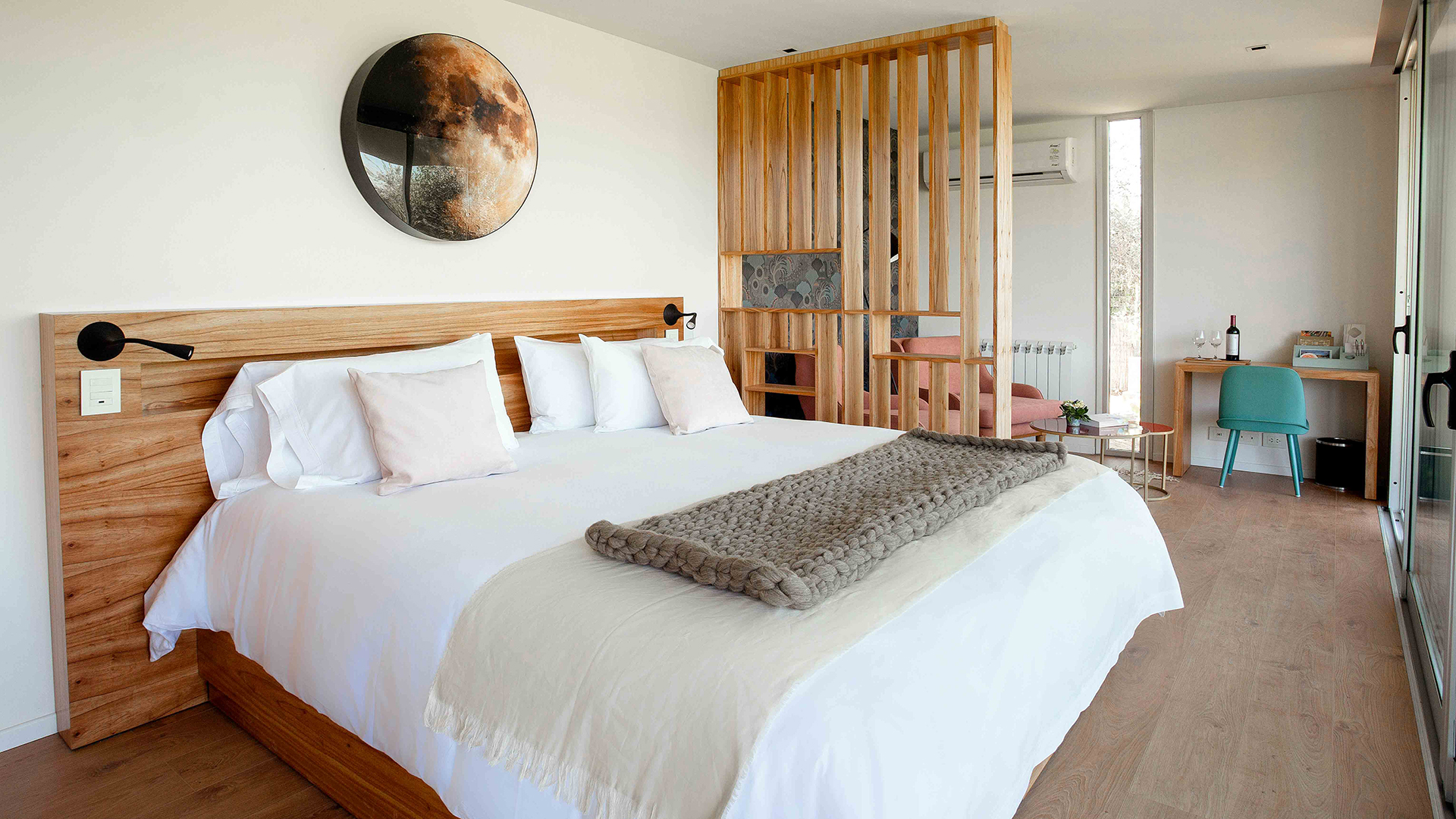 a bed with pillows and a wall art