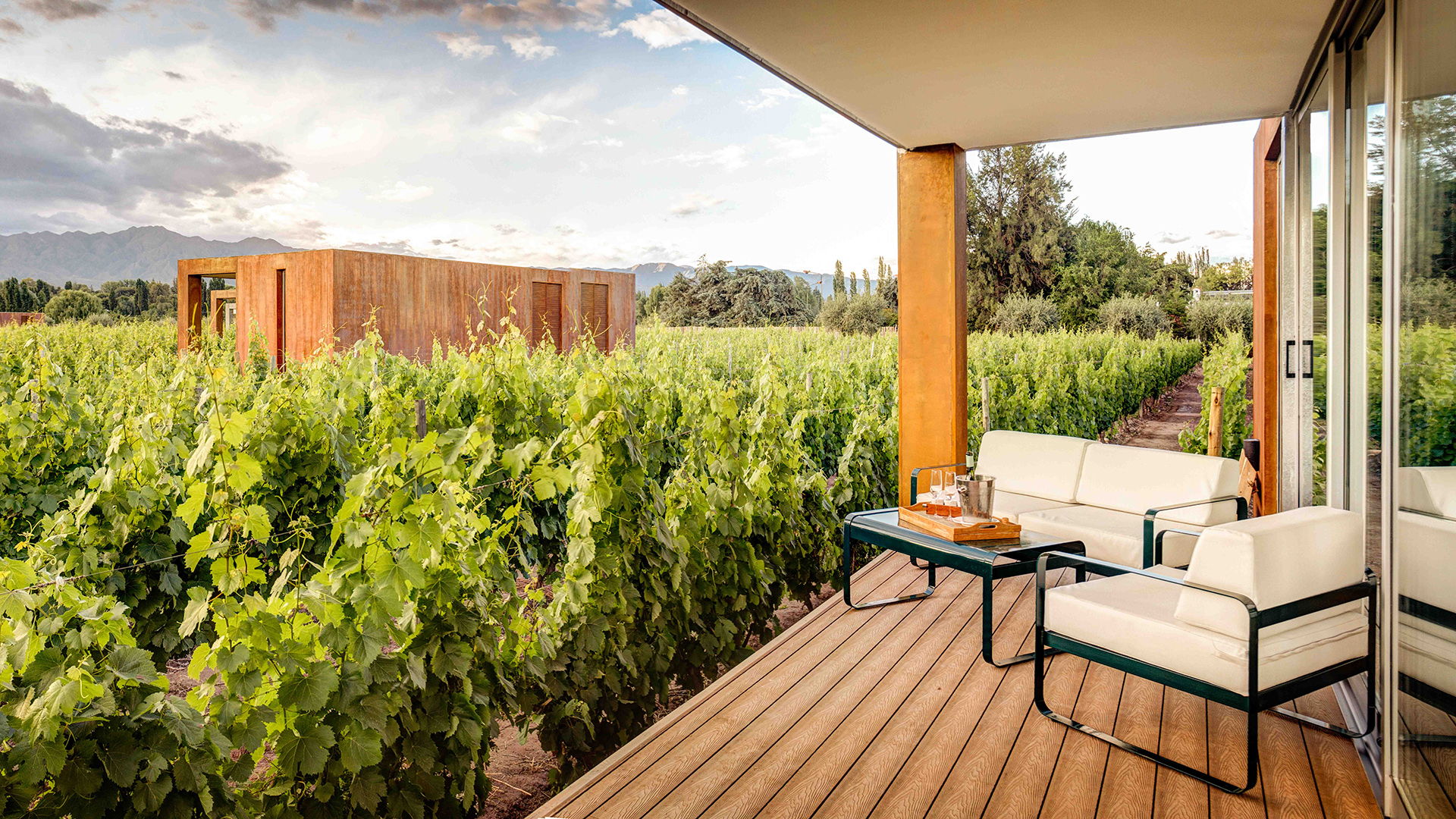a patio with a table and chairs on a wooden deck