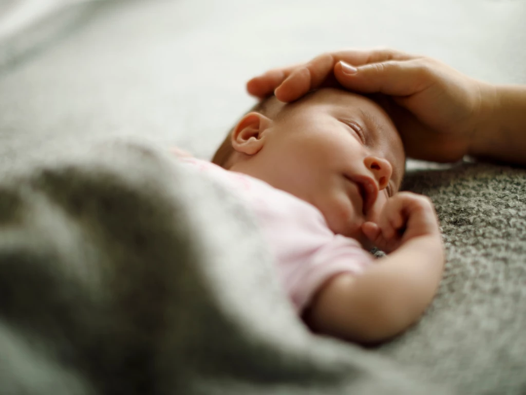 a baby being held by a hand
