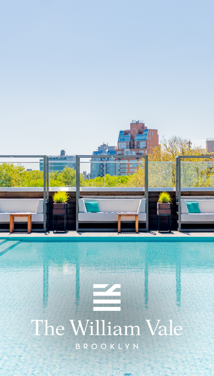 a pool with white couches and chairs
