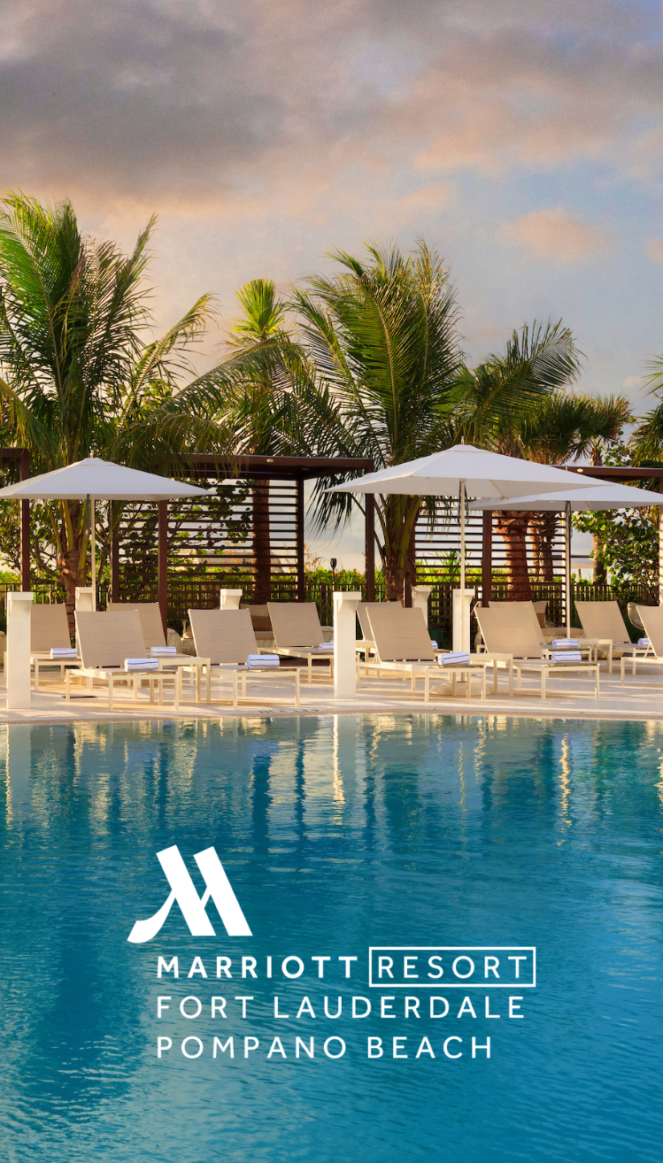a pool with lounge chairs and umbrellas