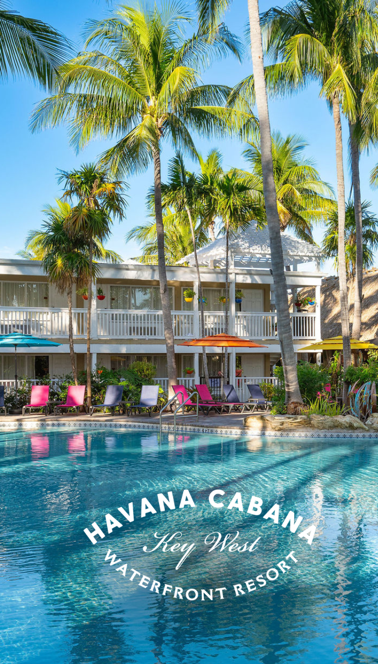 a pool with palm trees and chairs in front of a building