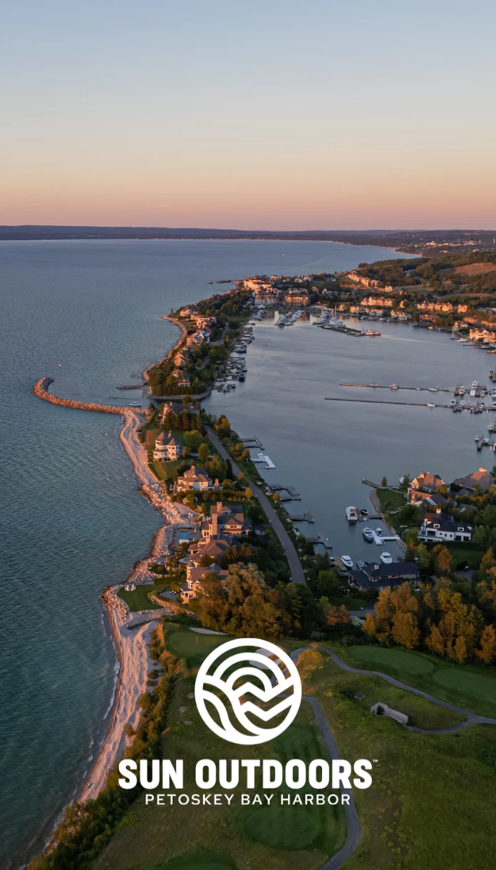 a aerial view of a body of water with houses and boats