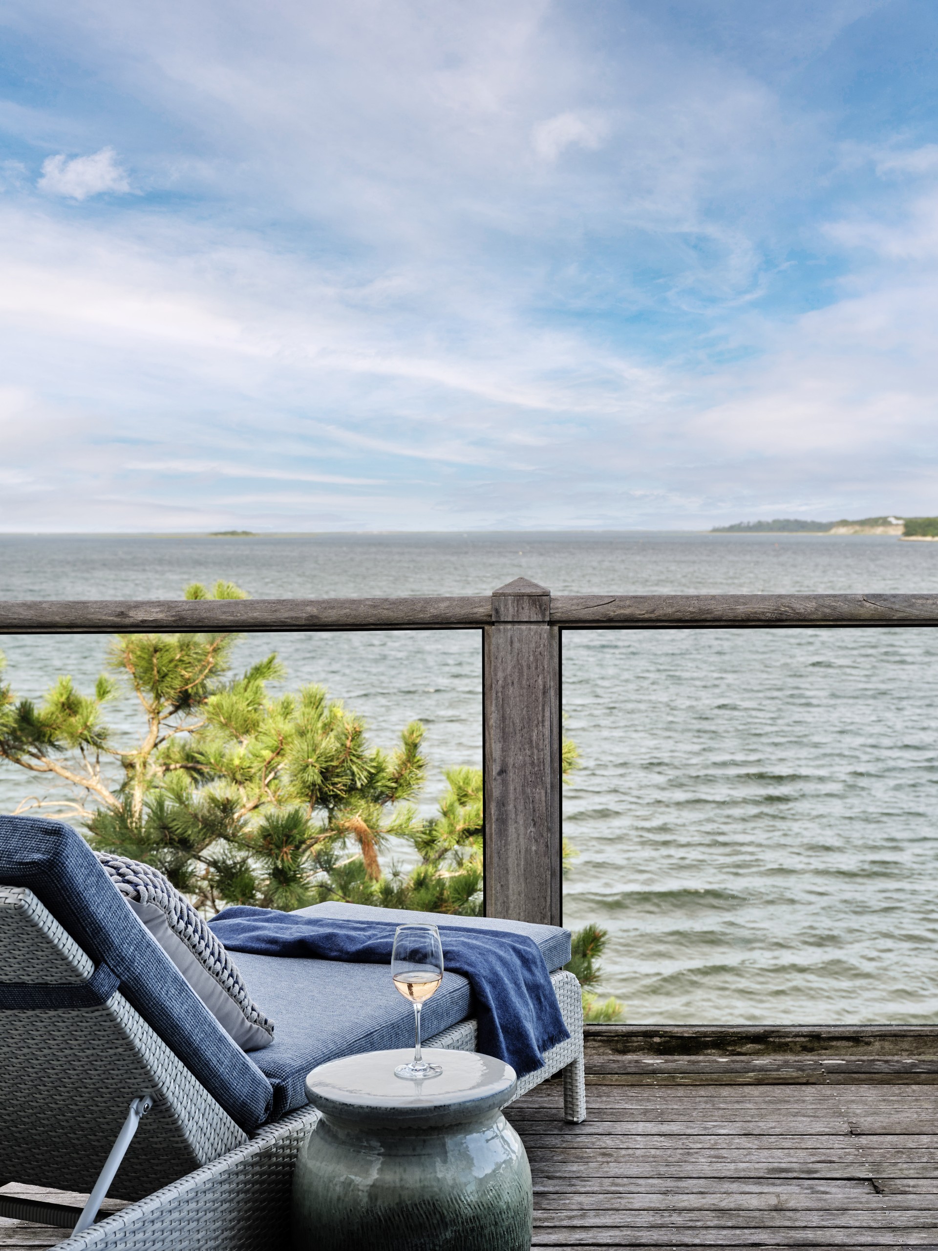 a chair on a deck overlooking a body of water
