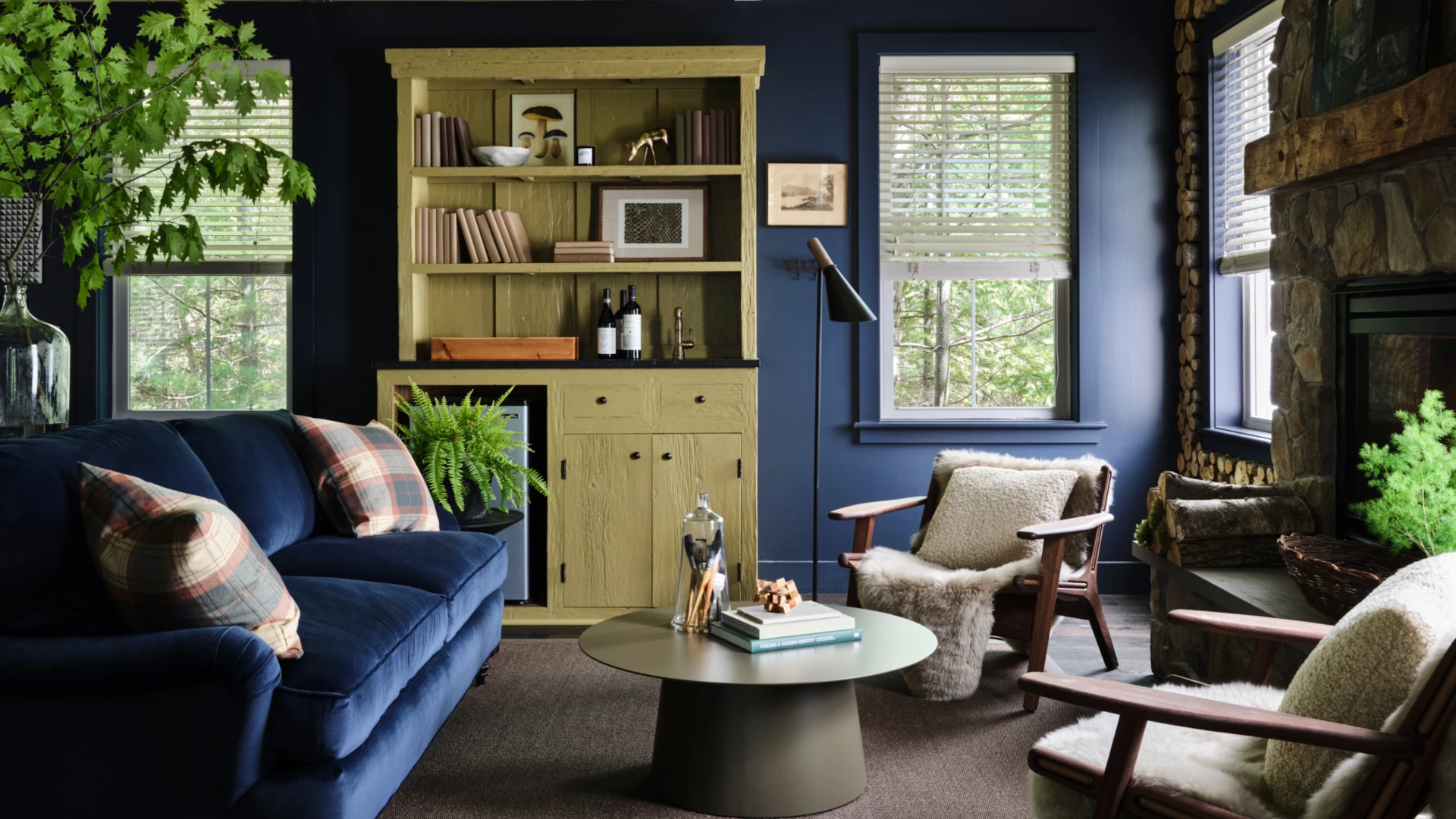 a living room with a blue couch, fireplace and a coffee table