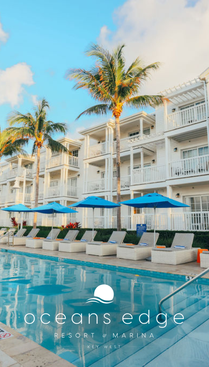 a pool with umbrellas and chairs in front of a hotel