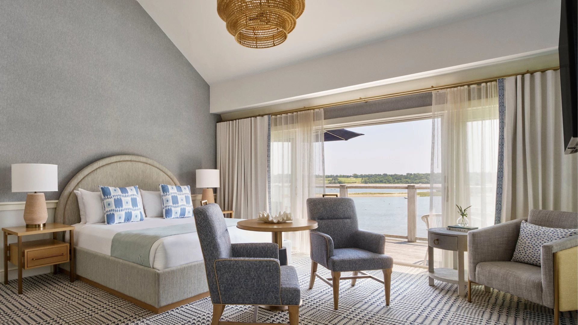 a room with a bed and chairs and a table