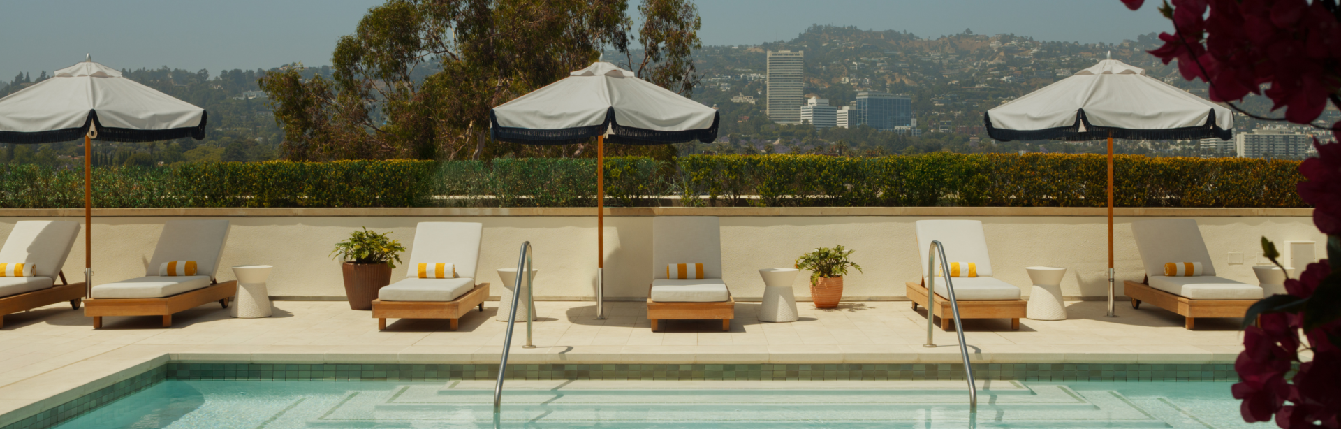 a pool with chairs and umbrella