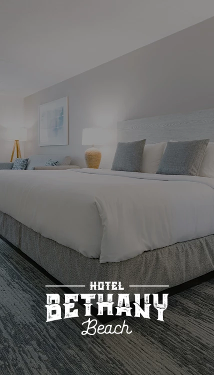 a bed with pillows and lamps in a hotel room