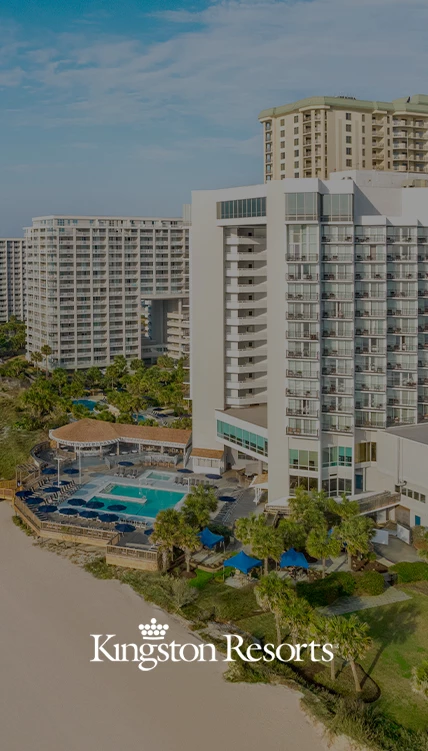 a large white building with a pool and trees