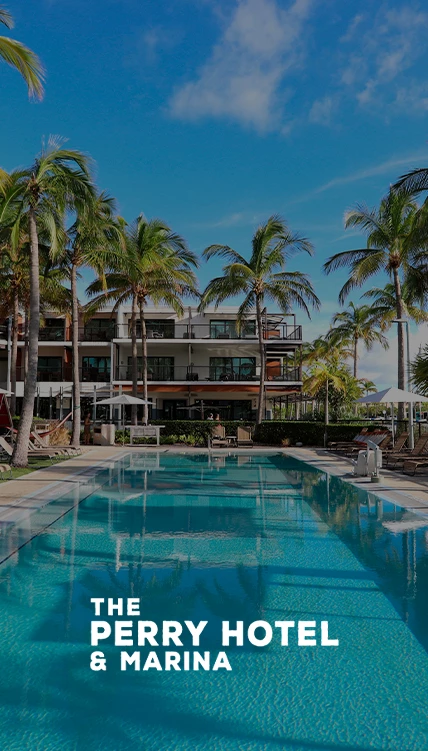 a swimming pool with palm trees and a building