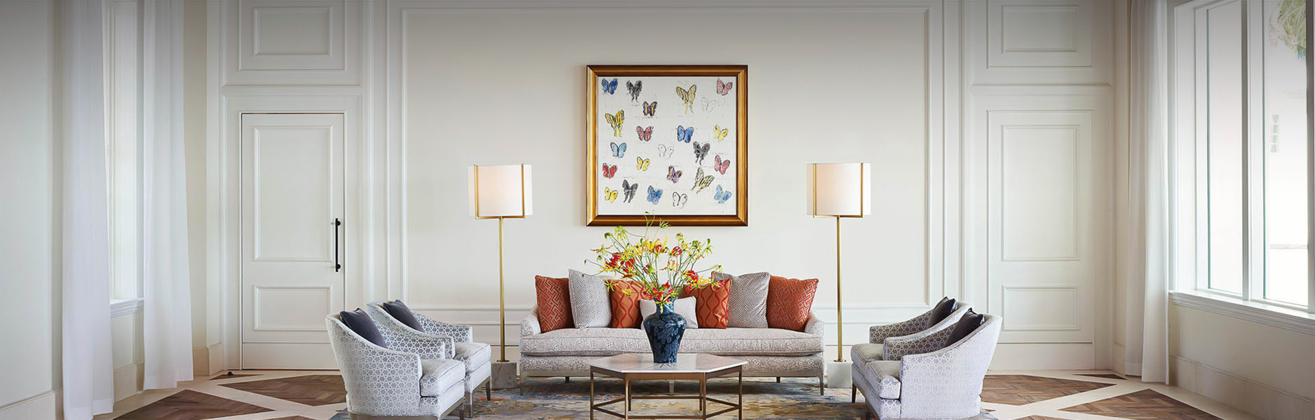 view of a spacious living room with a butterfly image above the couch