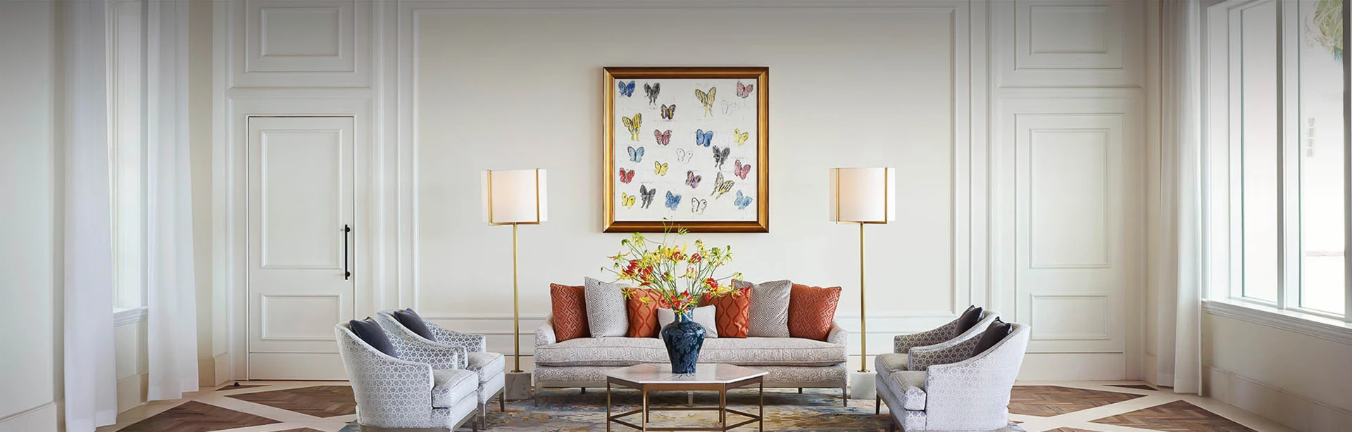 view of a spacious living room with a butterfly image above the couch
