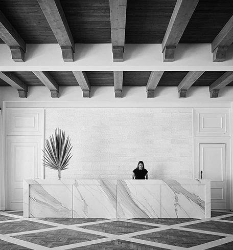 woman standing at the front desk in a lobby