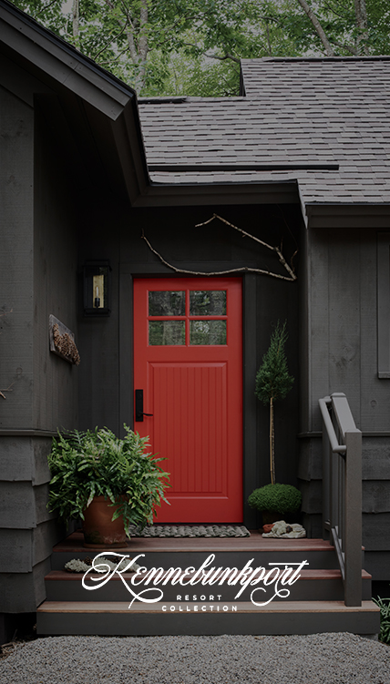 a red door with a window and a potted plant