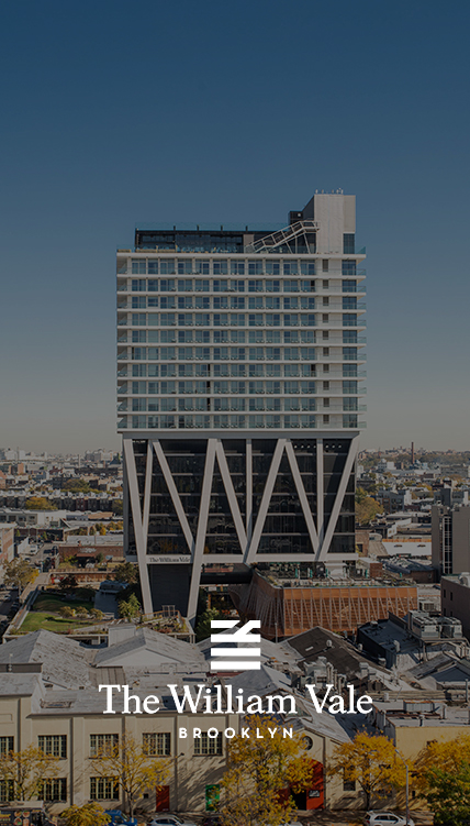 a tall building with a city in the background