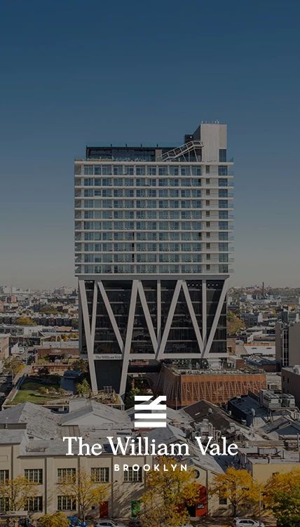 a tall building with a city in the background