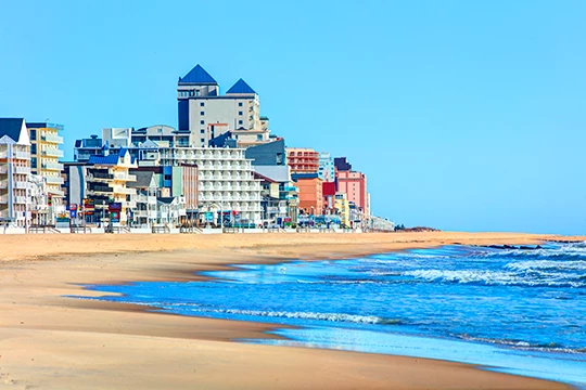 a beach with buildings and water