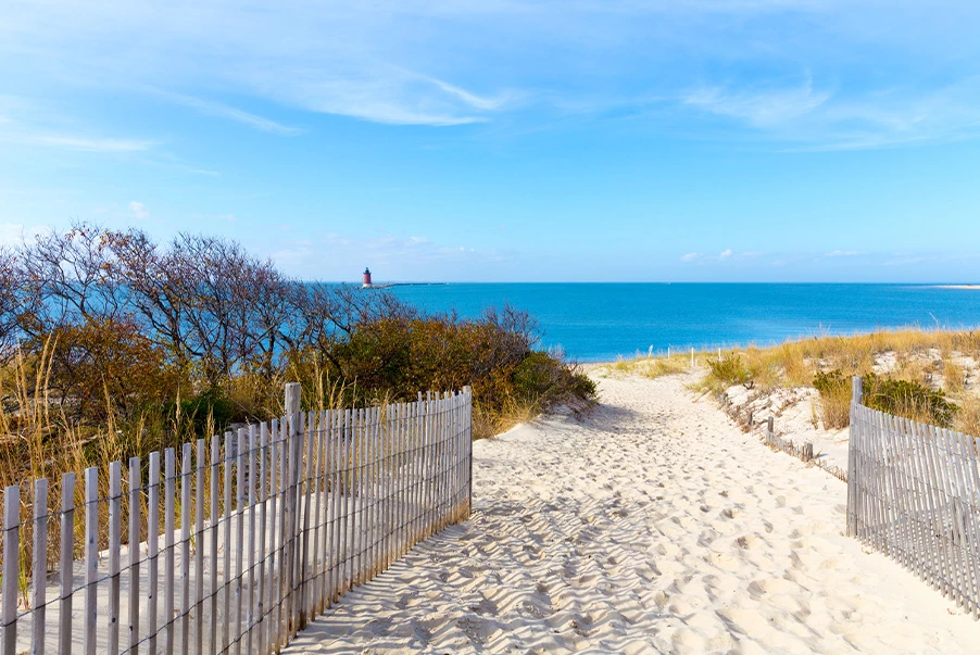 view of a sandy walkway leading to the beach