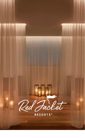 a room with white curtains and candles