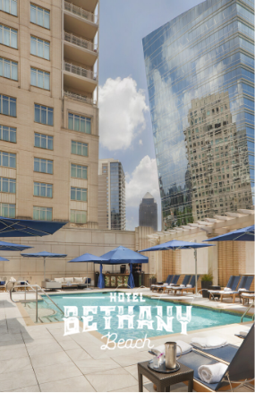 a pool with umbrellas and chairs in front of a building