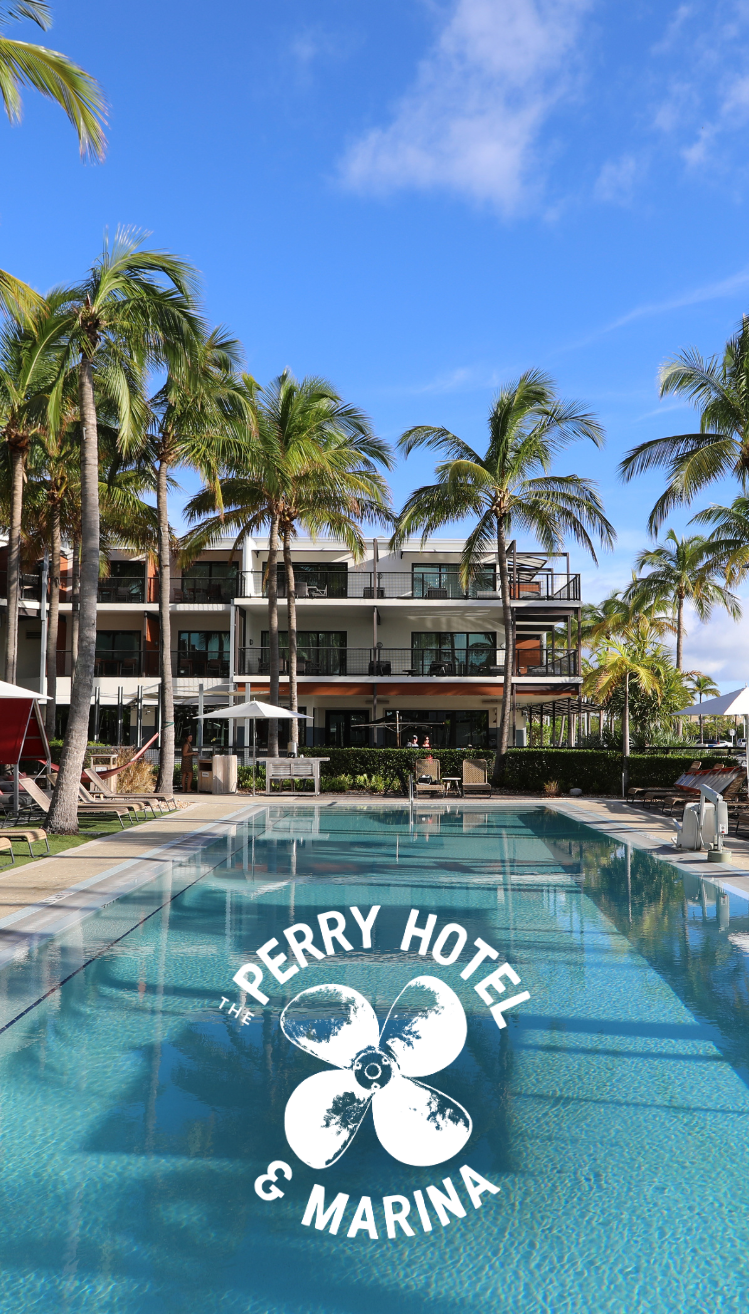 a swimming pool with palm trees and a building