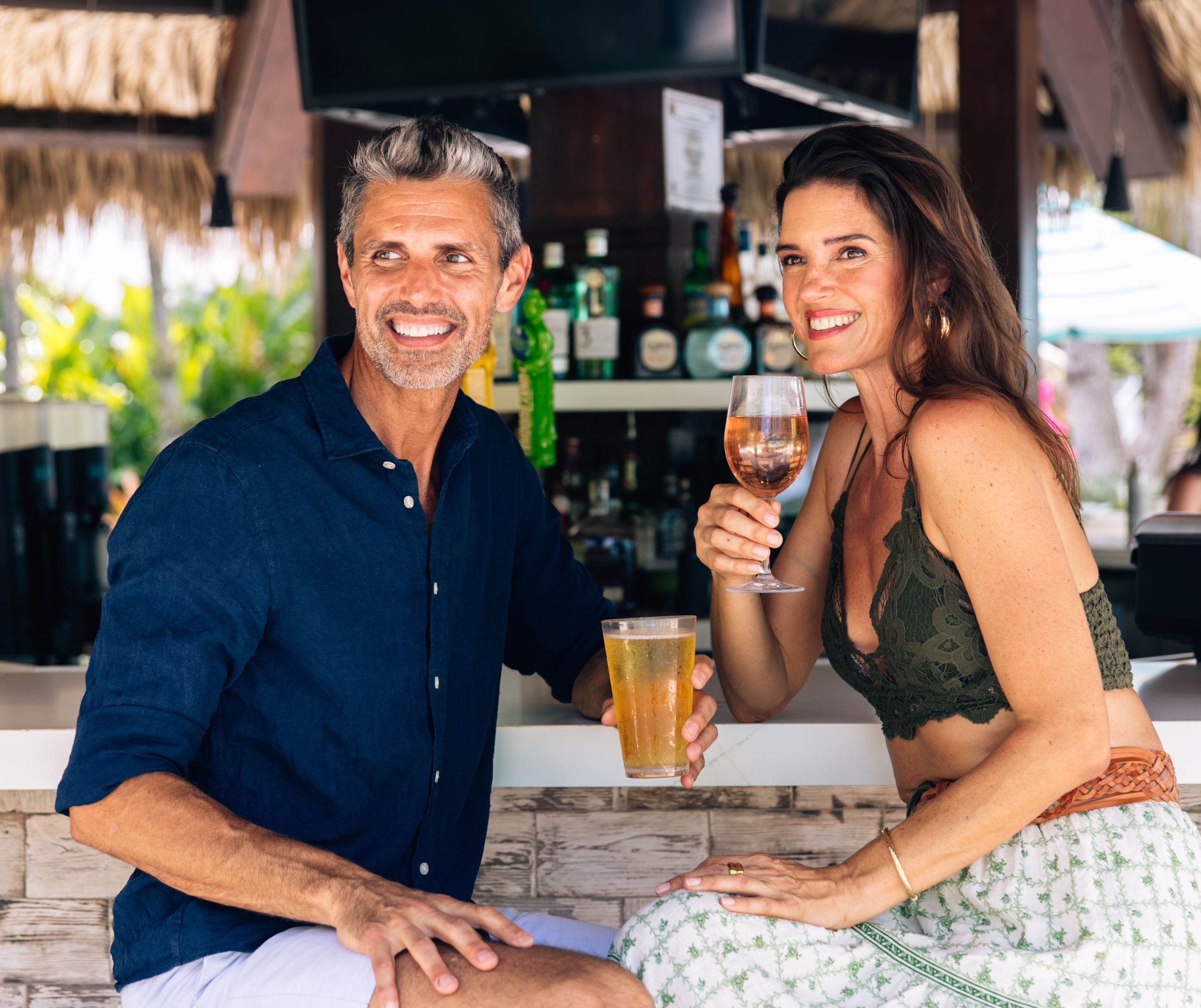 a man and woman holding drinks
