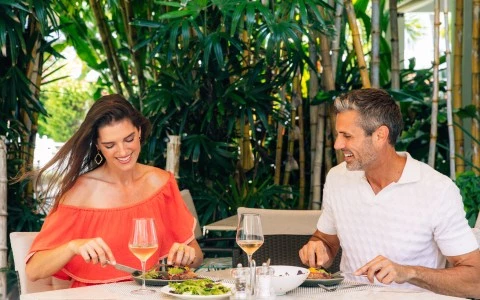 a man and woman eating at a table