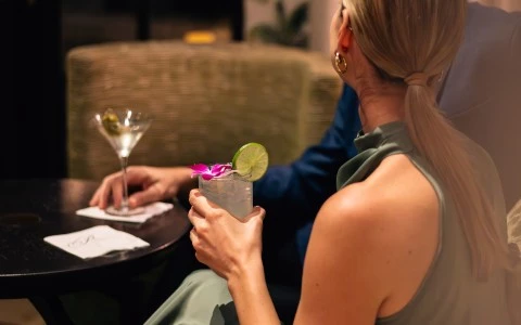 a woman holding a drink